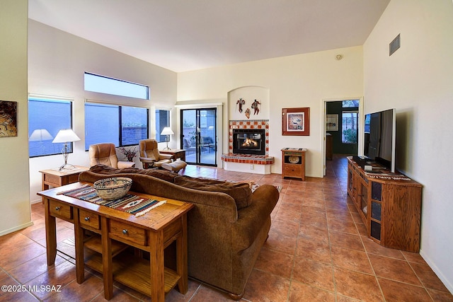 living room featuring tile patterned floors and a brick fireplace