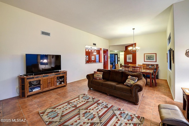 living room with tile patterned floors and a notable chandelier