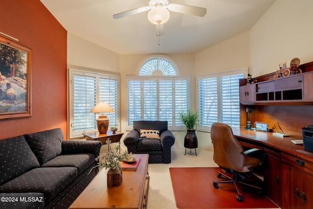 office space with a wealth of natural light, carpet, lofted ceiling, and ceiling fan