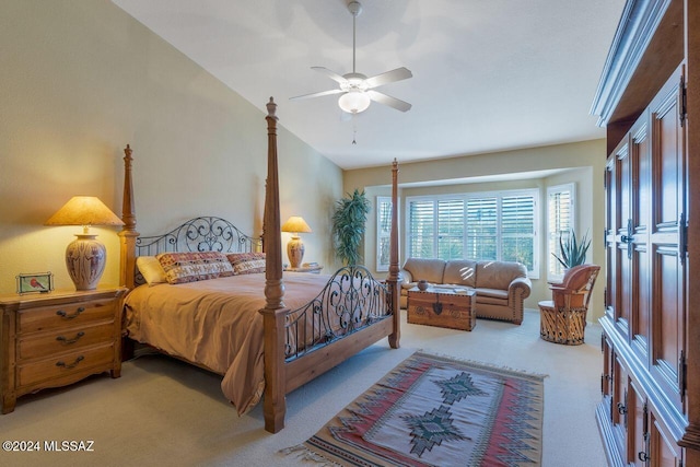 bedroom featuring ceiling fan, light carpet, and vaulted ceiling