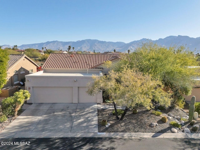 view of front of property featuring a mountain view and a garage