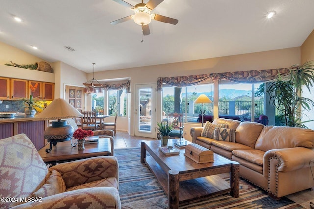 living room featuring light tile patterned floors, ceiling fan, and lofted ceiling