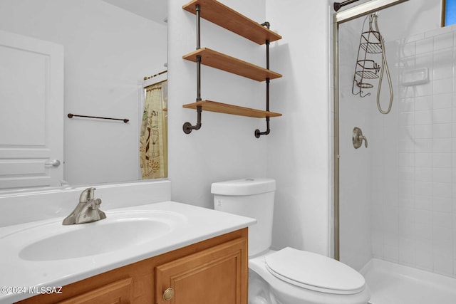 bathroom with toilet, vanity, and a shower with shower curtain