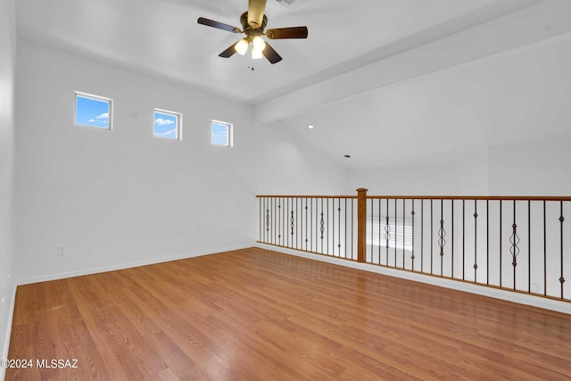 empty room featuring ceiling fan, light hardwood / wood-style floors, and lofted ceiling with beams