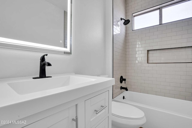 full bathroom with vanity, toilet, and tiled shower / bath