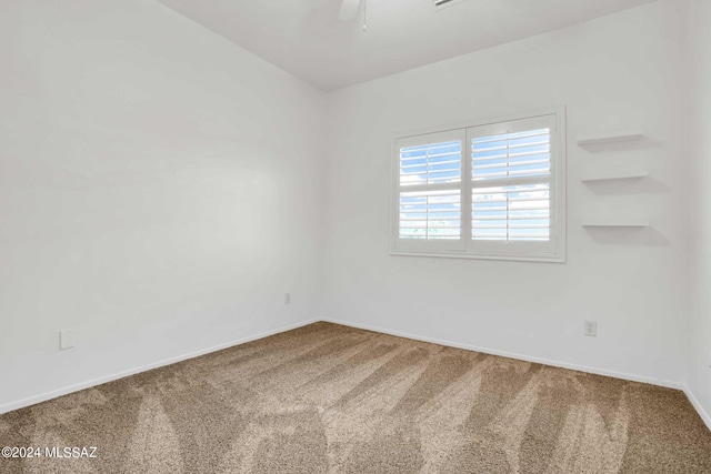 empty room featuring carpet flooring and ceiling fan