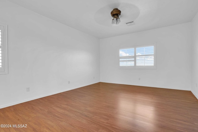 empty room featuring ceiling fan and hardwood / wood-style floors