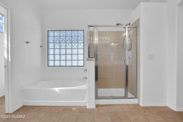 bathroom featuring tile patterned flooring and separate shower and tub