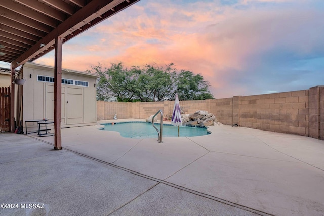 pool at dusk featuring a patio area