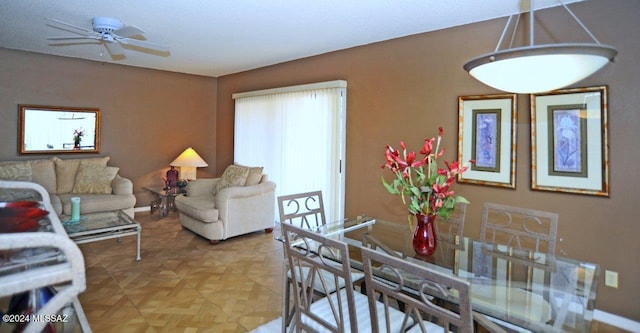 dining room featuring ceiling fan and light parquet flooring