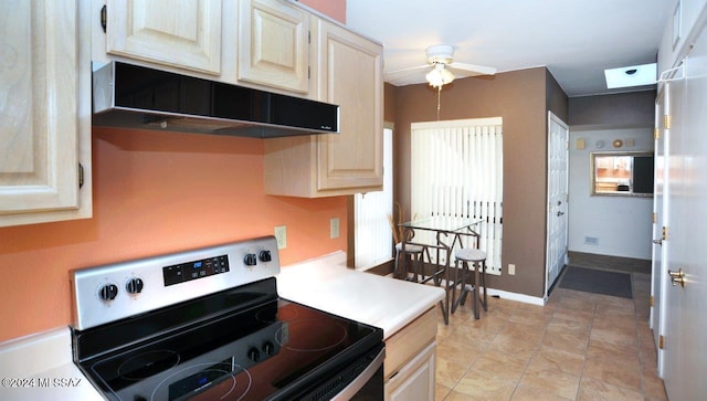 kitchen with stainless steel range with electric stovetop, ceiling fan, and light tile patterned flooring