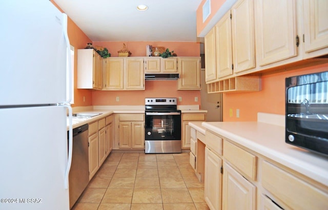 kitchen featuring light tile patterned floors and stainless steel appliances