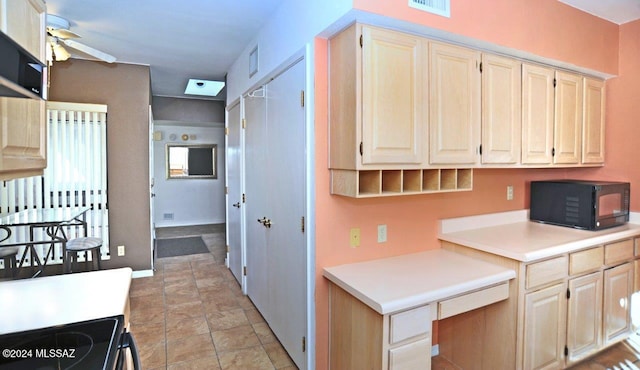 kitchen featuring ceiling fan and range