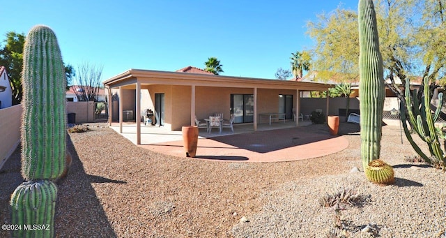 rear view of house with a patio