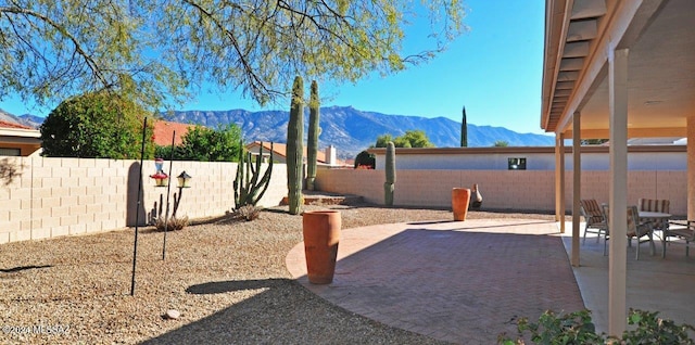 view of yard featuring a mountain view and a patio