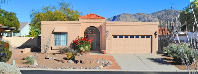 view of front of property featuring a mountain view and a garage