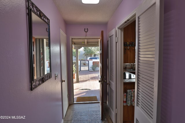 entryway with a textured ceiling