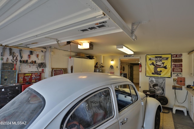 garage with a workshop area and a garage door opener