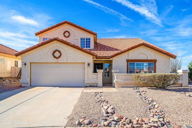 mediterranean / spanish-style house featuring a garage