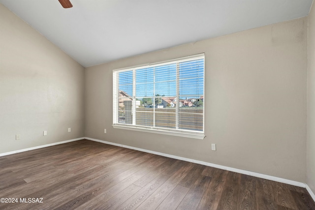 spare room with ceiling fan, dark hardwood / wood-style flooring, and vaulted ceiling