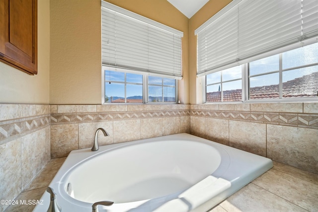 bathroom featuring a bathtub and vaulted ceiling