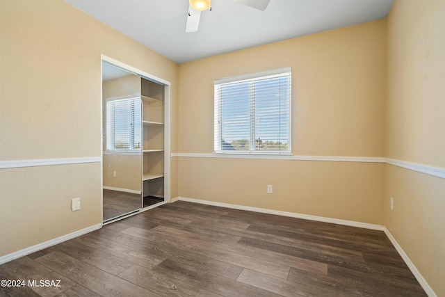 unfurnished bedroom featuring dark hardwood / wood-style floors, a closet, and ceiling fan