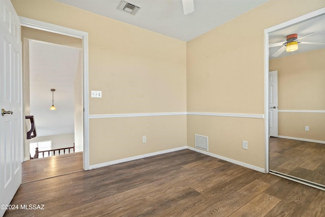 empty room featuring ceiling fan and dark hardwood / wood-style floors