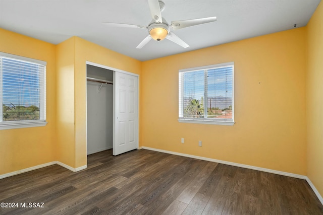 unfurnished bedroom featuring dark hardwood / wood-style flooring, a closet, and ceiling fan