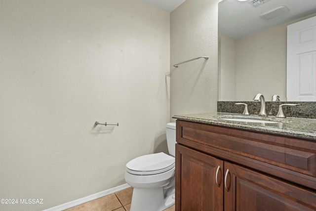 bathroom with vanity, tile patterned floors, and toilet