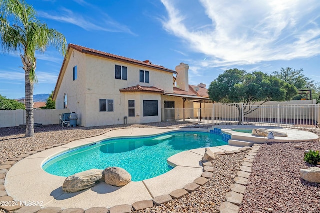 view of pool with a patio area and an in ground hot tub