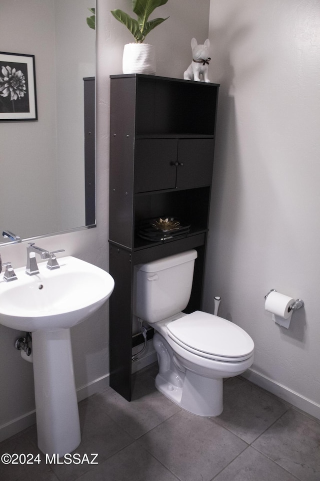 bathroom with tile patterned flooring, toilet, and sink