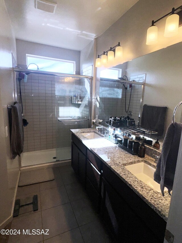 bathroom featuring vanity, tile patterned floors, and walk in shower