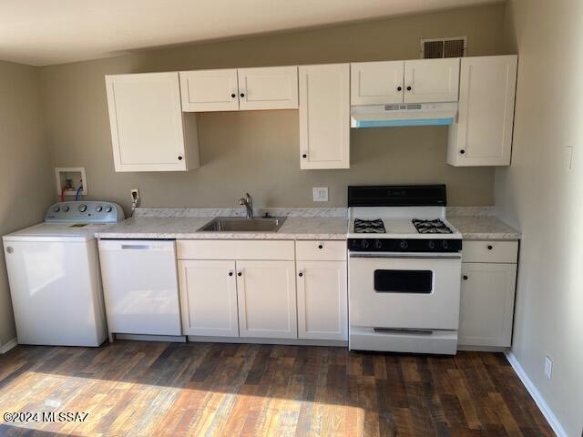 kitchen featuring white cabinetry, sink, dark wood-type flooring, washer / clothes dryer, and white appliances