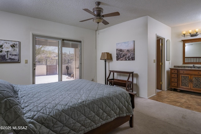 bedroom featuring arched walkways, access to exterior, carpet, a textured ceiling, and a sink