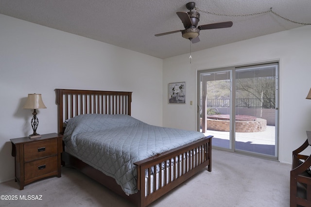 bedroom with light carpet, ceiling fan, a textured ceiling, and access to exterior