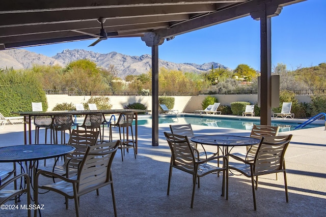 view of patio featuring a mountain view and a fenced in pool