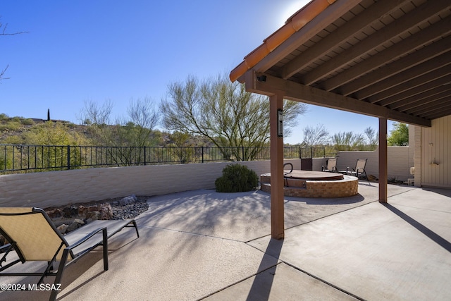 view of patio featuring a fenced backyard and a fire pit