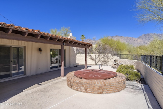 view of patio featuring a fenced backyard and a mountain view