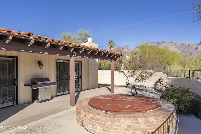 view of patio with grilling area and a mountain view