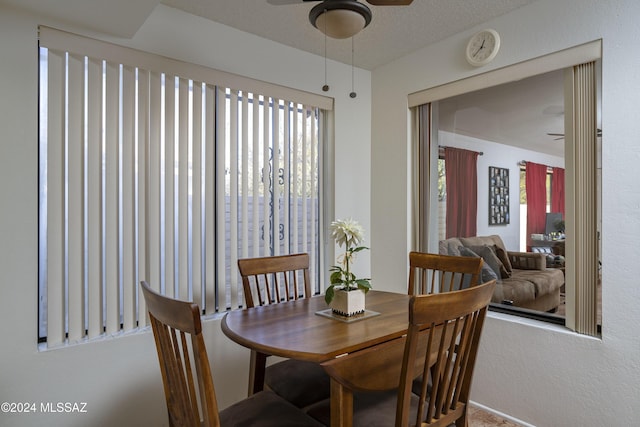 dining area with a textured ceiling and ceiling fan