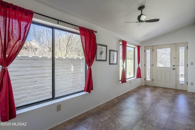 entryway featuring lofted ceiling, ceiling fan, and baseboards