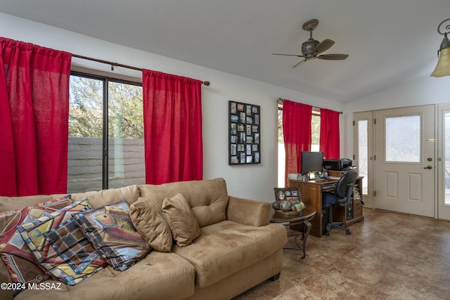 living room featuring ceiling fan, a healthy amount of sunlight, and vaulted ceiling