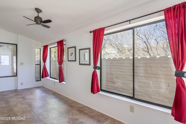 spare room featuring vaulted ceiling and ceiling fan