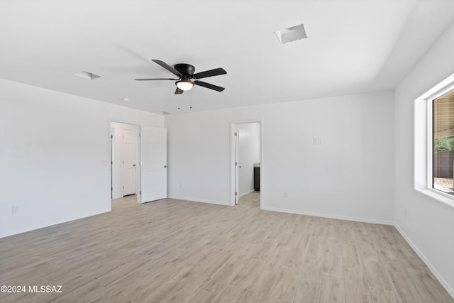 spare room with light wood-type flooring and ceiling fan