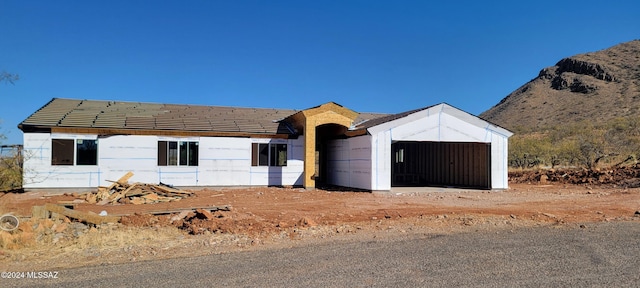 view of front of house with a mountain view and a garage