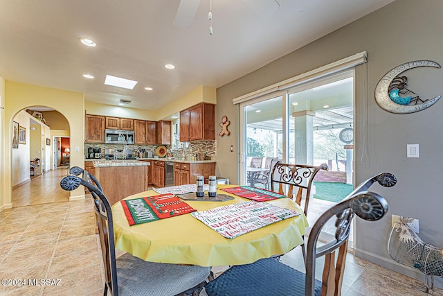 tiled dining space featuring ceiling fan