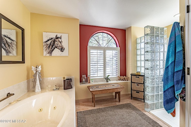 bathroom featuring hardwood / wood-style floors and a tub