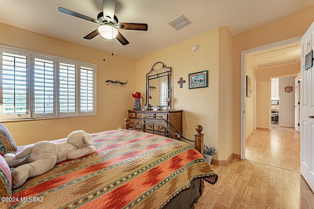 bedroom with ceiling fan and light hardwood / wood-style flooring