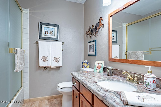 full bathroom featuring vanity, toilet, and combined bath / shower with glass door