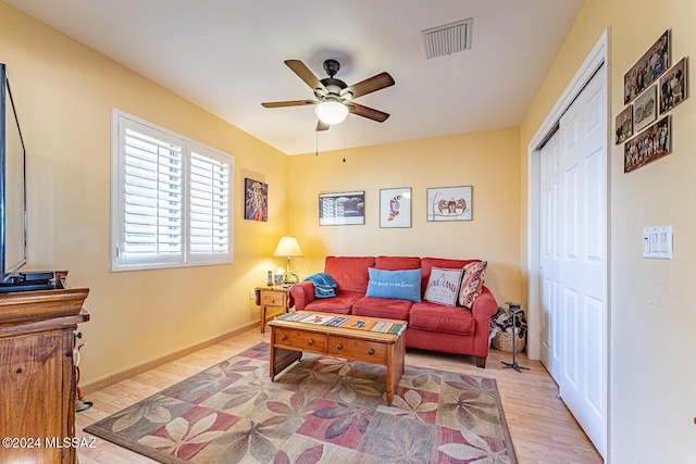 living room featuring ceiling fan and light hardwood / wood-style flooring